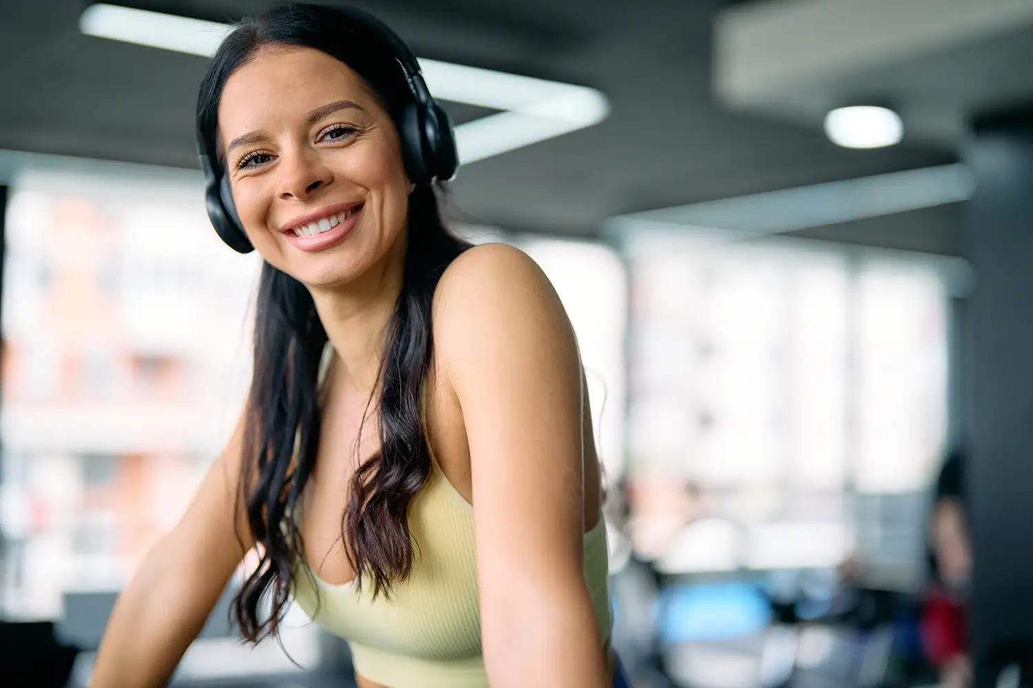 athletic woman at the gym wearing headphones