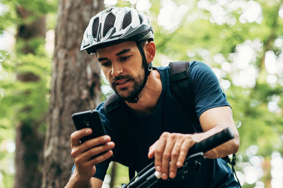 male cyclist using smart phone