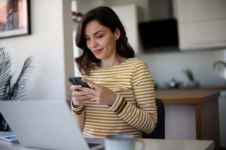 woman using smartphone at home