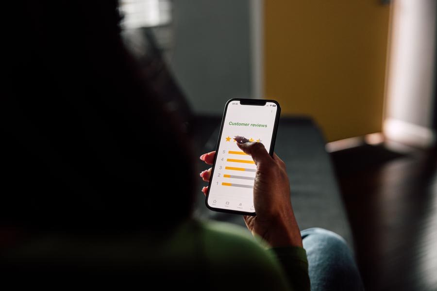 Person holding smart phone with rating app